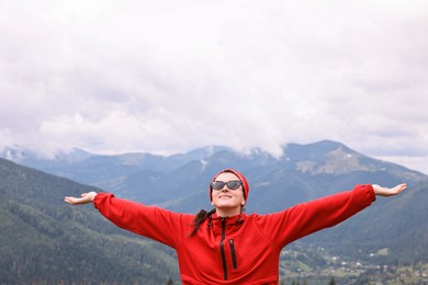 Happy young hiker in mountains. Active tourism