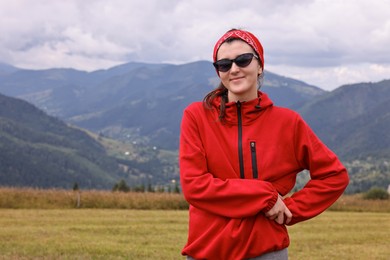 Photo of Happy young hiker in mountains, space for text