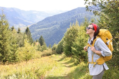 Young hiker with backpack enjoying time in forest