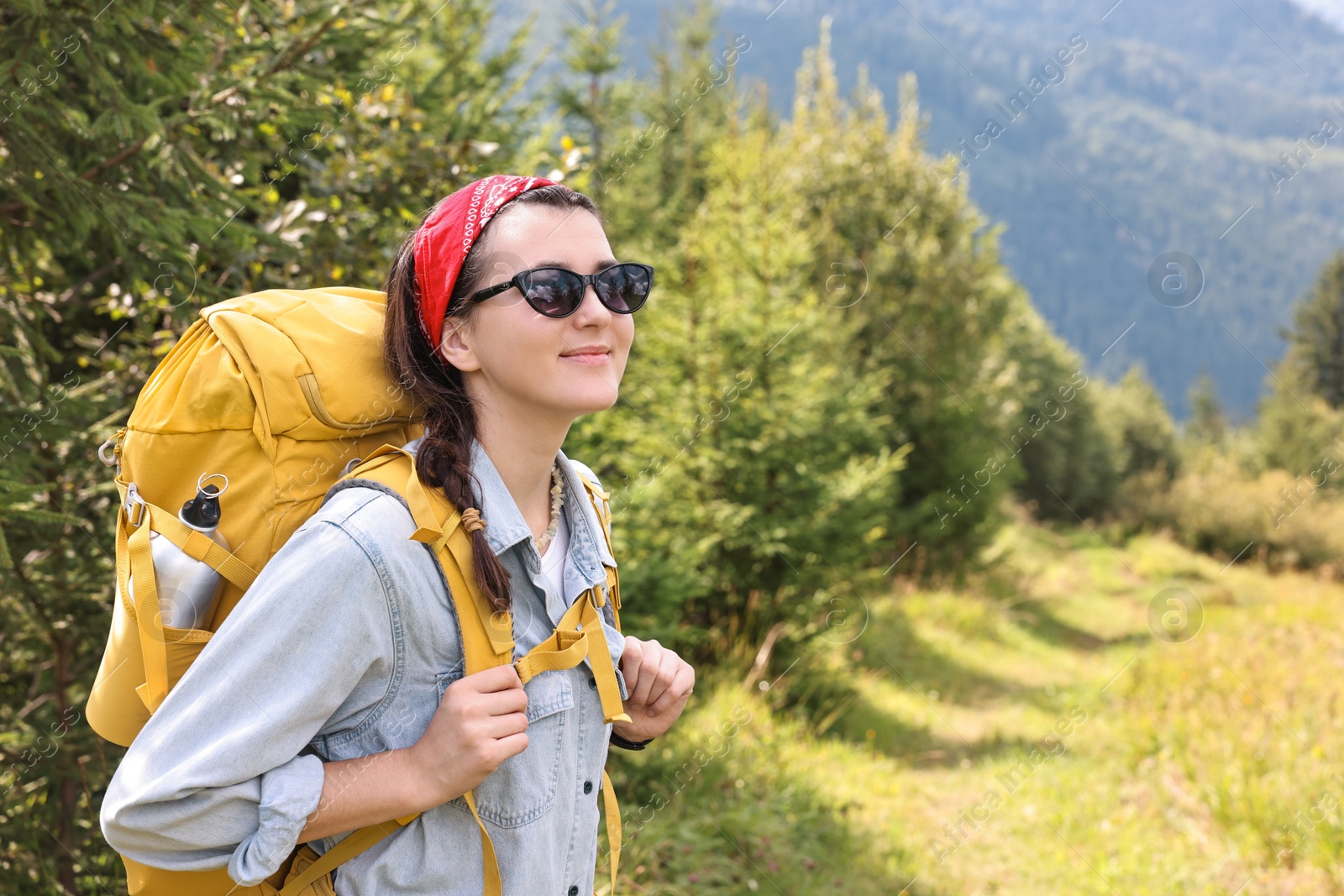 Photo of Young hiker with backpack enjoying time in forest