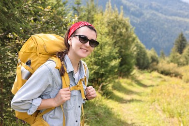 Photo of Young hiker with backpack enjoying time in forest