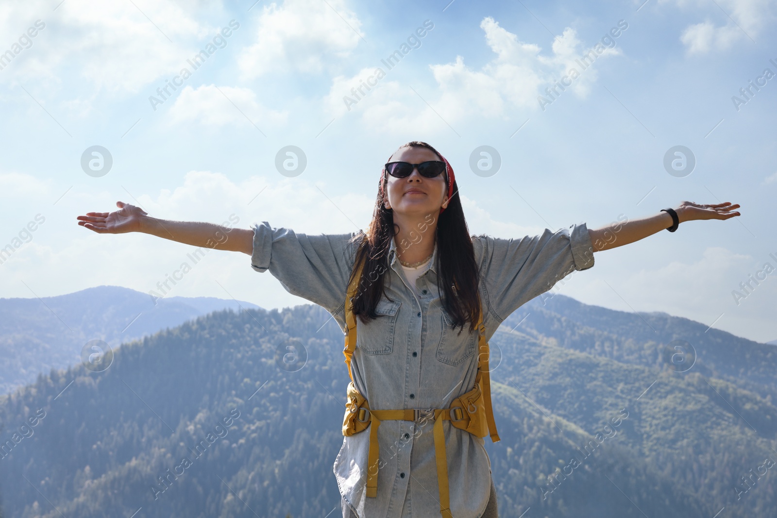 Photo of Young hiker with backpack in mountains on sunny day