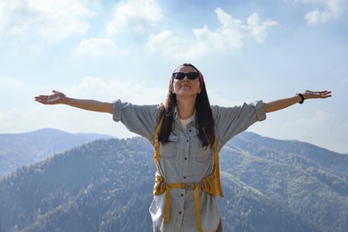 Photo of Young hiker with backpack in mountains on sunny day