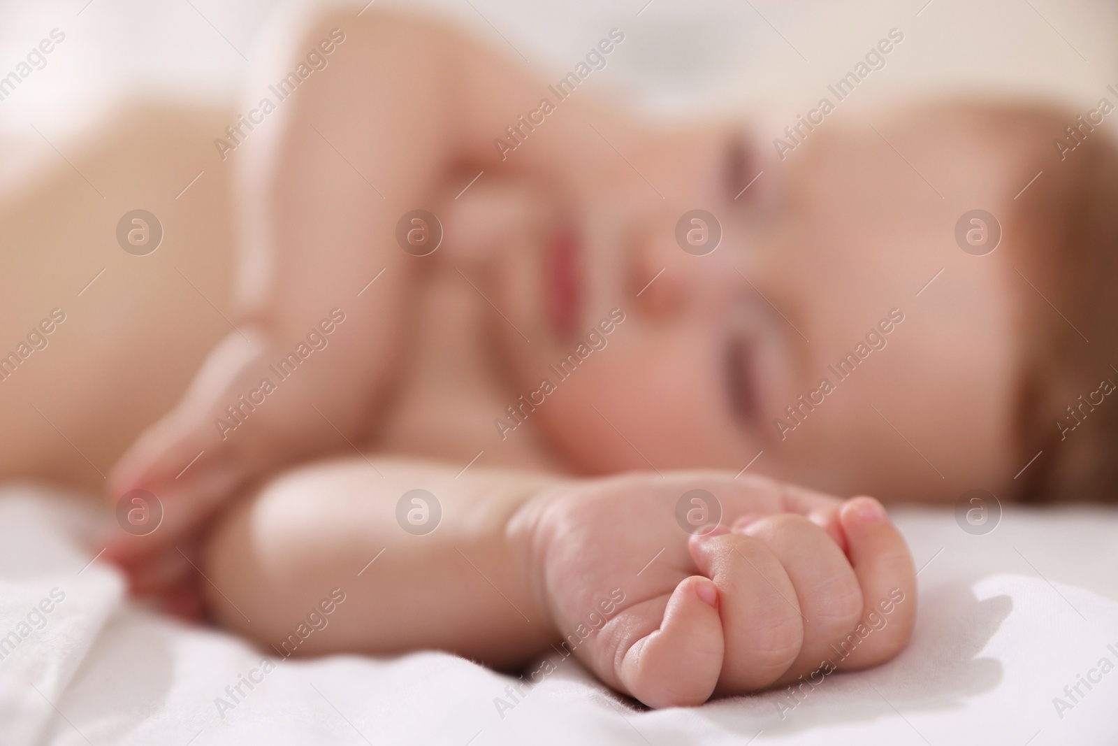 Photo of Cute little baby sleeping on bed, selective focus