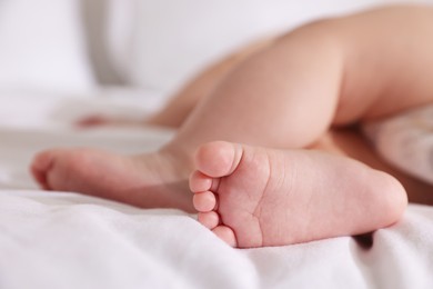 Photo of Cute little baby sleeping on bed at home, closeup