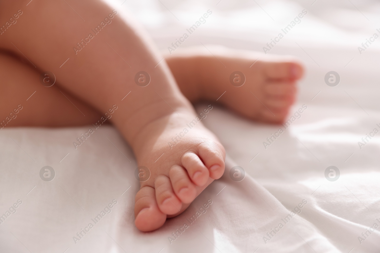 Photo of Cute little baby sleeping on bed at home, closeup