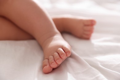 Photo of Cute little baby sleeping on bed at home, closeup