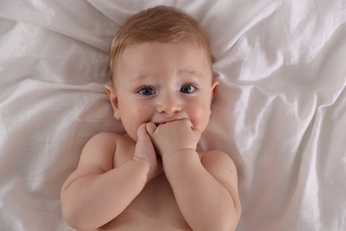 Cute little baby on bed, top view