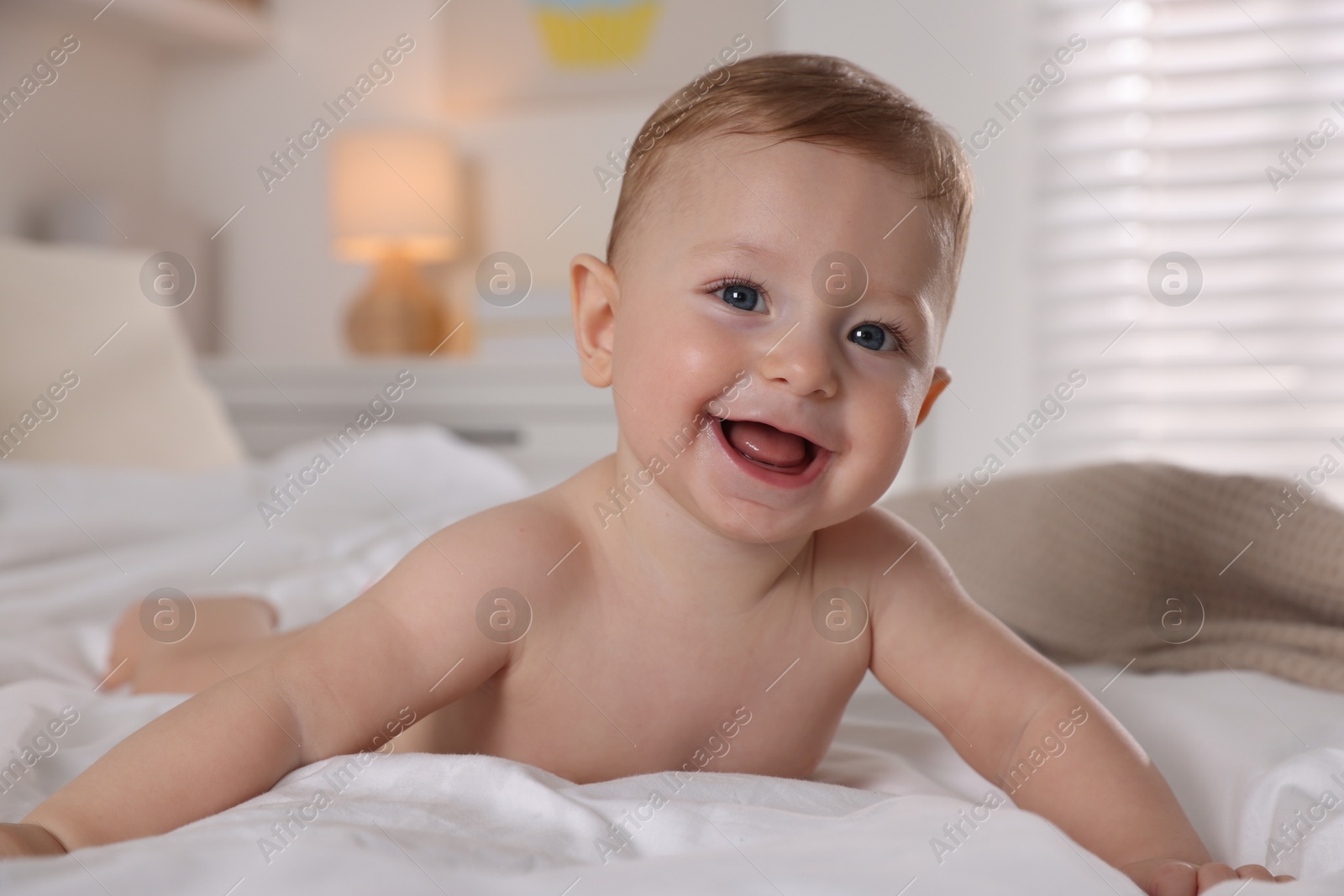 Photo of Cute little baby on bed at home