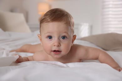 Photo of Cute little baby on bed at home