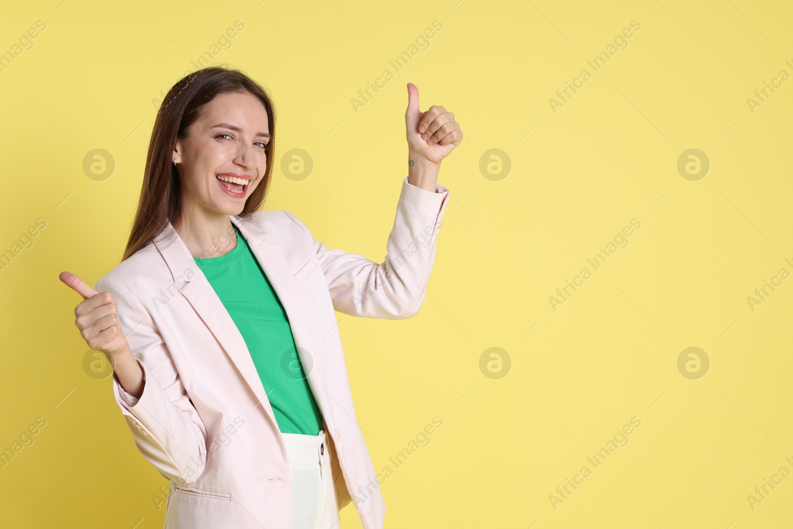 Photo of Happy winner on yellow background, space for text