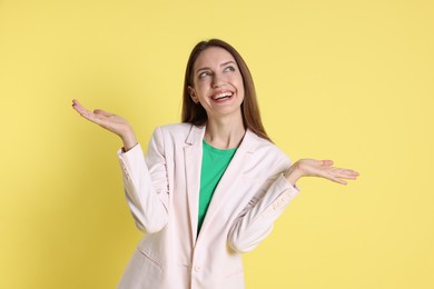 Portrait of happy winner on yellow background