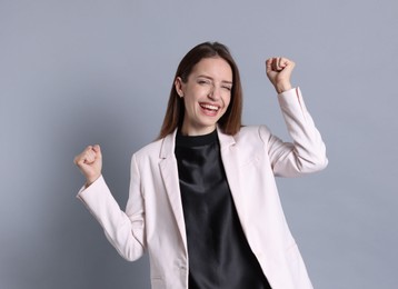 Photo of Portrait of happy winner on gray background