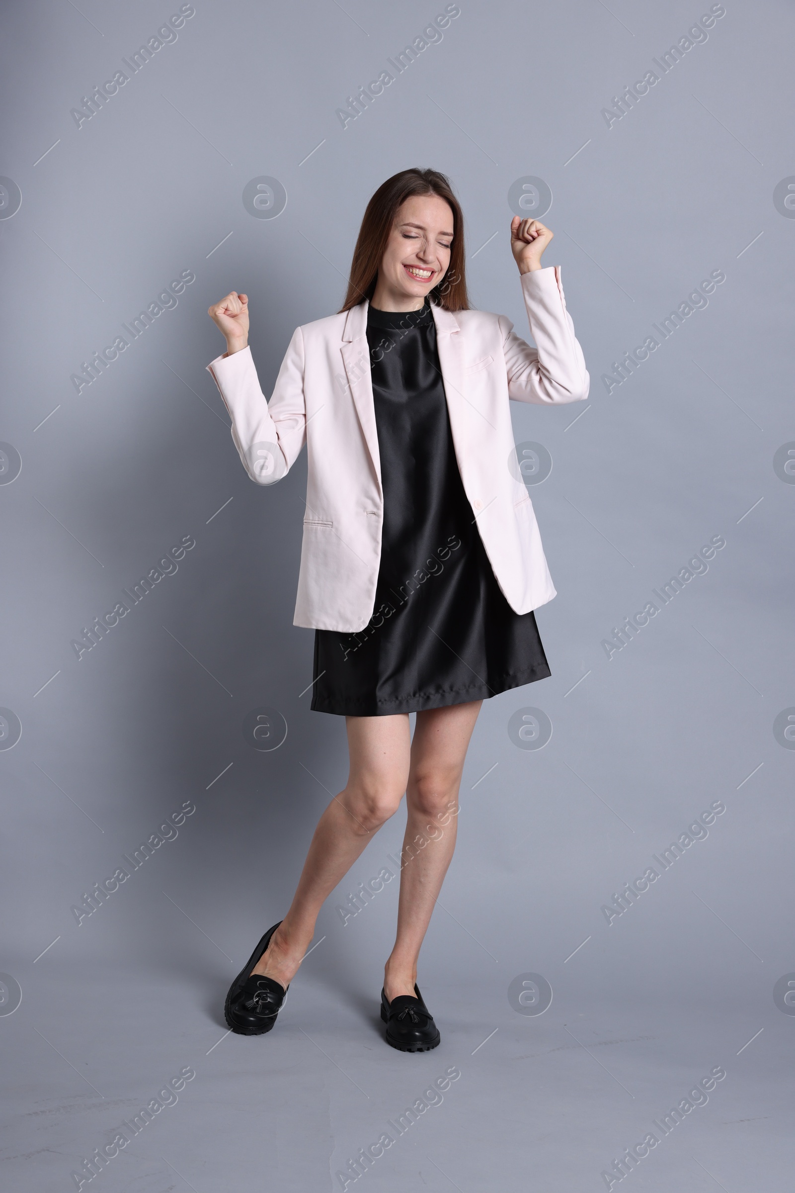 Photo of Portrait of happy winner on gray background