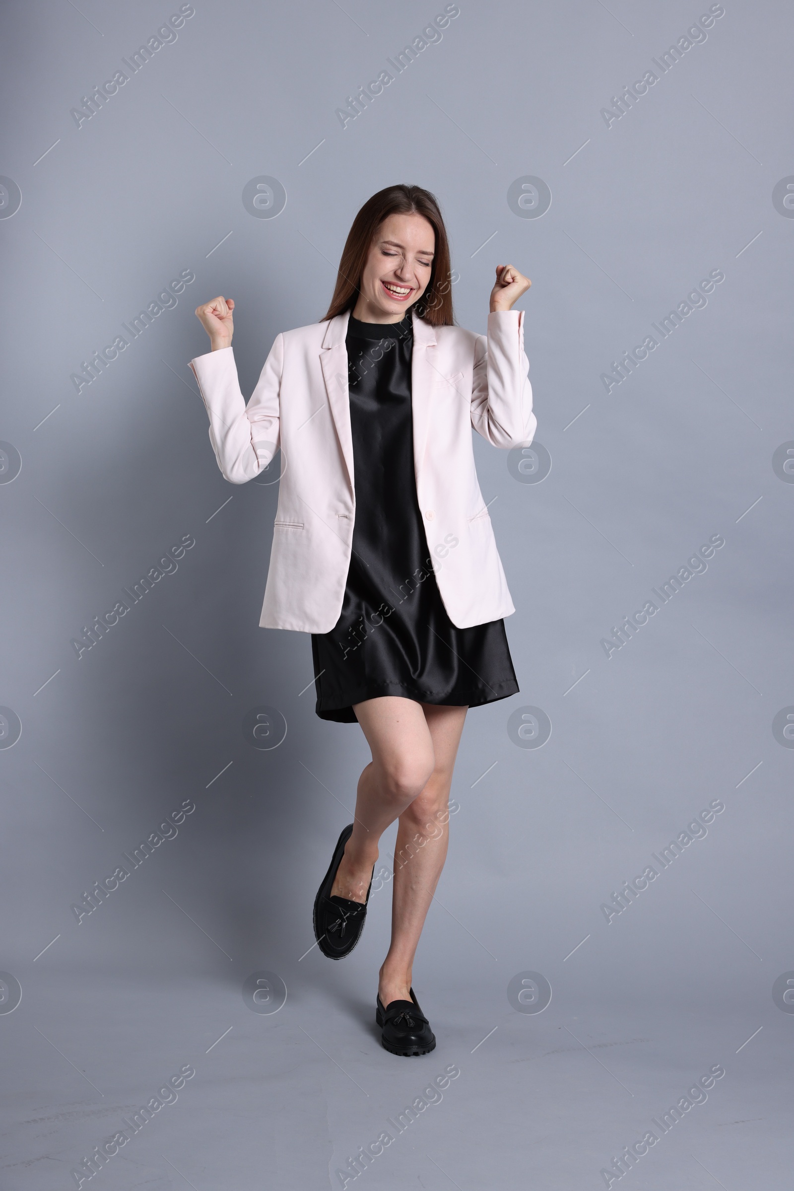 Photo of Portrait of happy winner on gray background