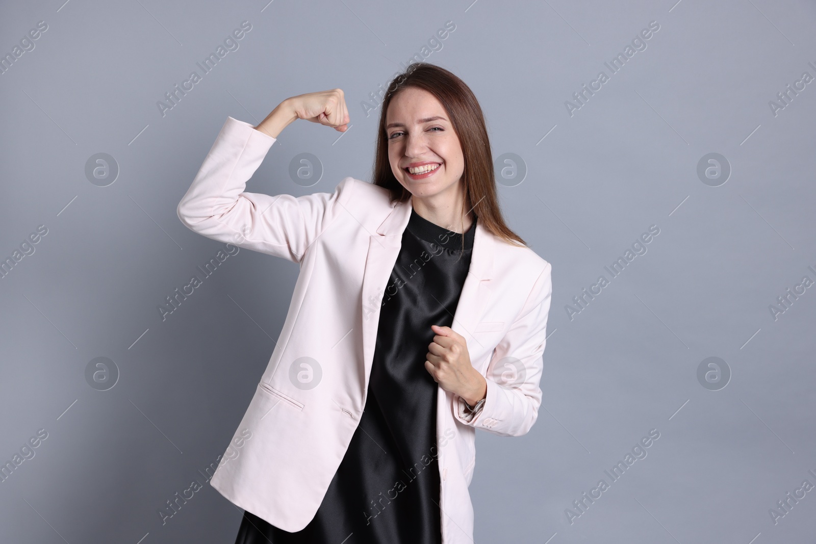 Photo of Portrait of happy winner on gray background