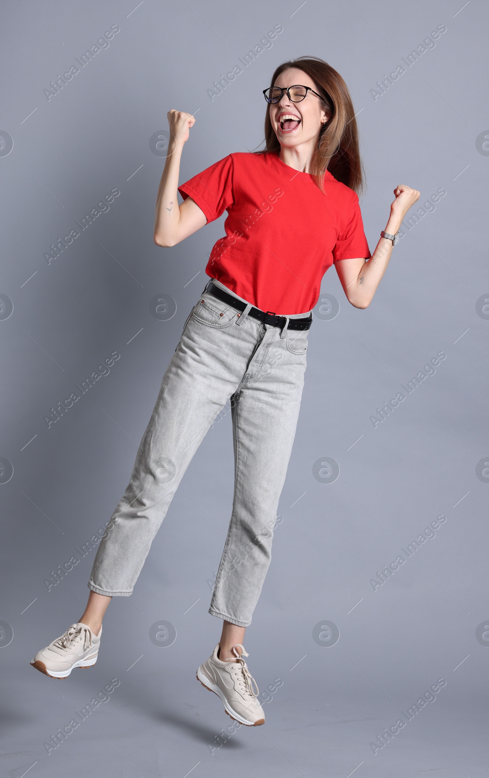 Photo of Portrait of happy winner on gray background