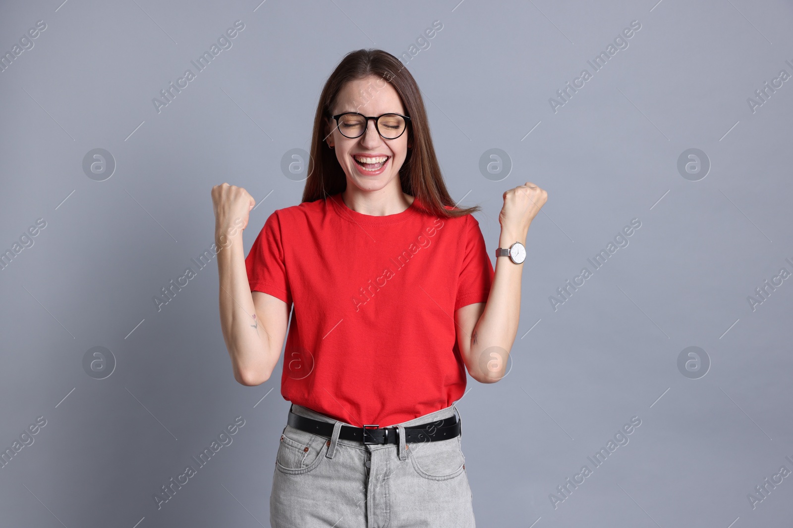 Photo of Portrait of happy winner on gray background