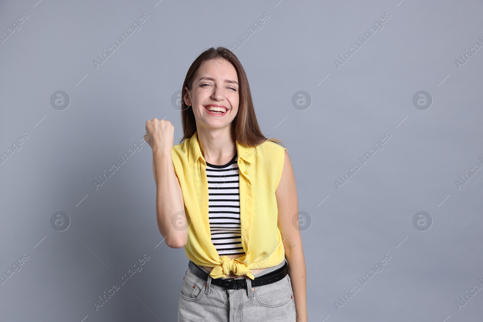 Photo of Portrait of happy winner on gray background