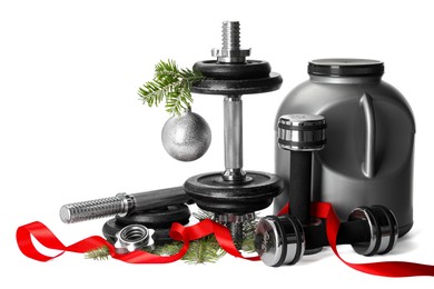 Photo of Dumbbells, container with supplement and Christmas decor isolated on white