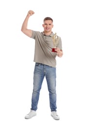 Happy winner with golden trophy cup on white background