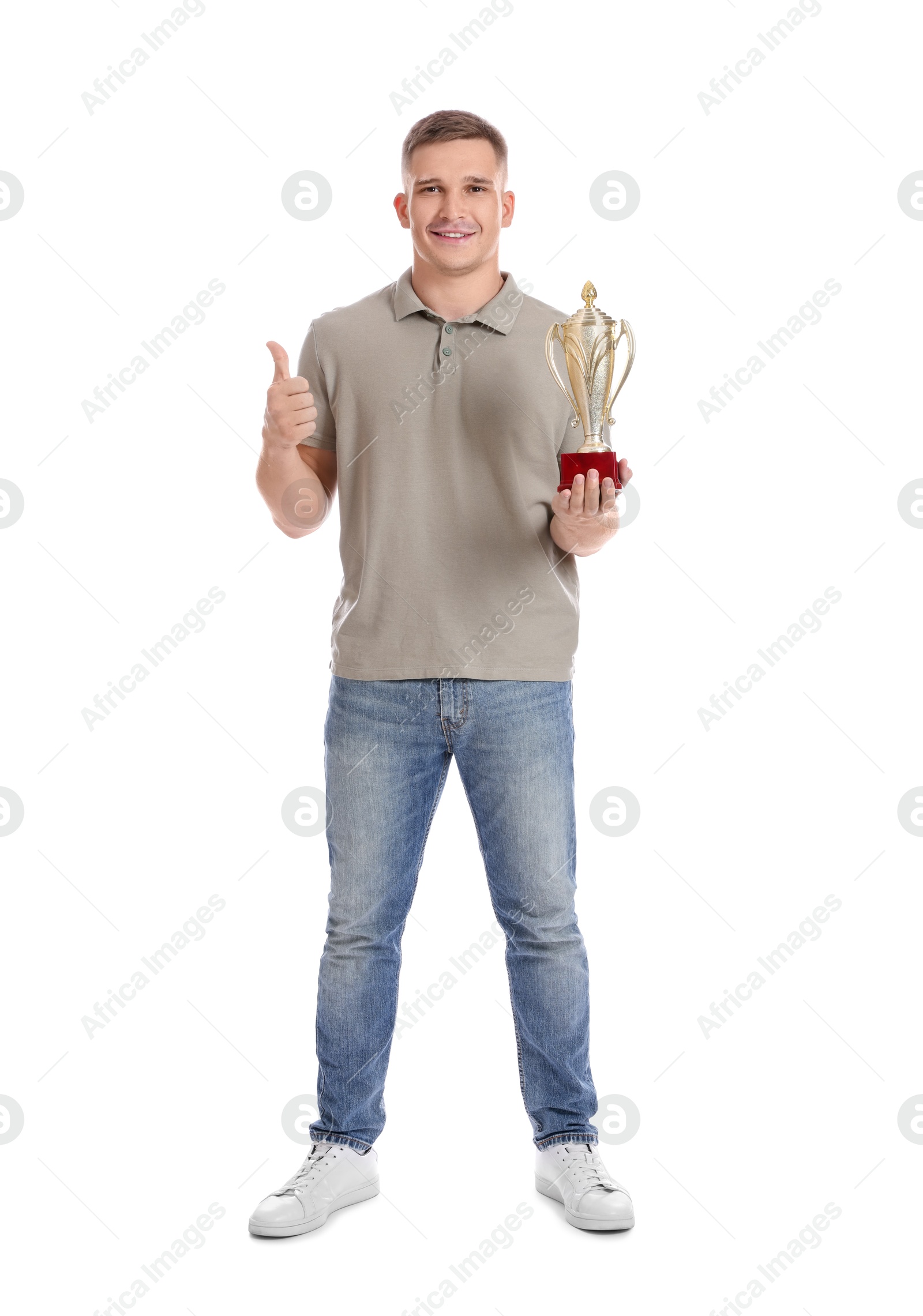 Photo of Happy winner with golden trophy cup showing thumbs up on white background