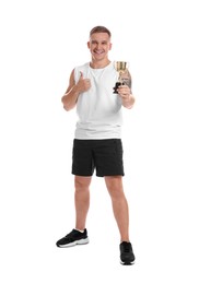 Happy winner with golden trophy cup showing thumbs up on white background