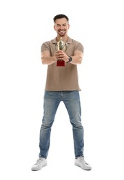 Photo of Happy winner with golden trophy cup on white background