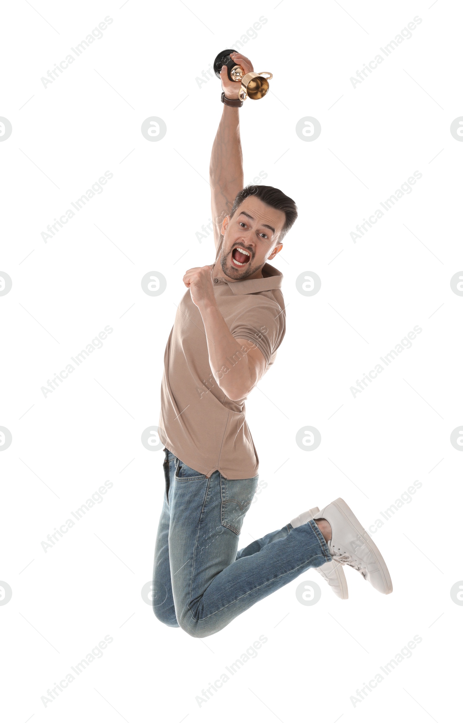 Photo of Happy winner with golden trophy cup jumping on white background