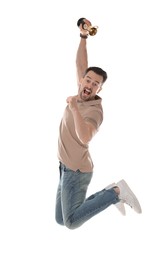 Photo of Happy winner with golden trophy cup jumping on white background