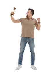 Photo of Happy winner with golden trophy cup on white background