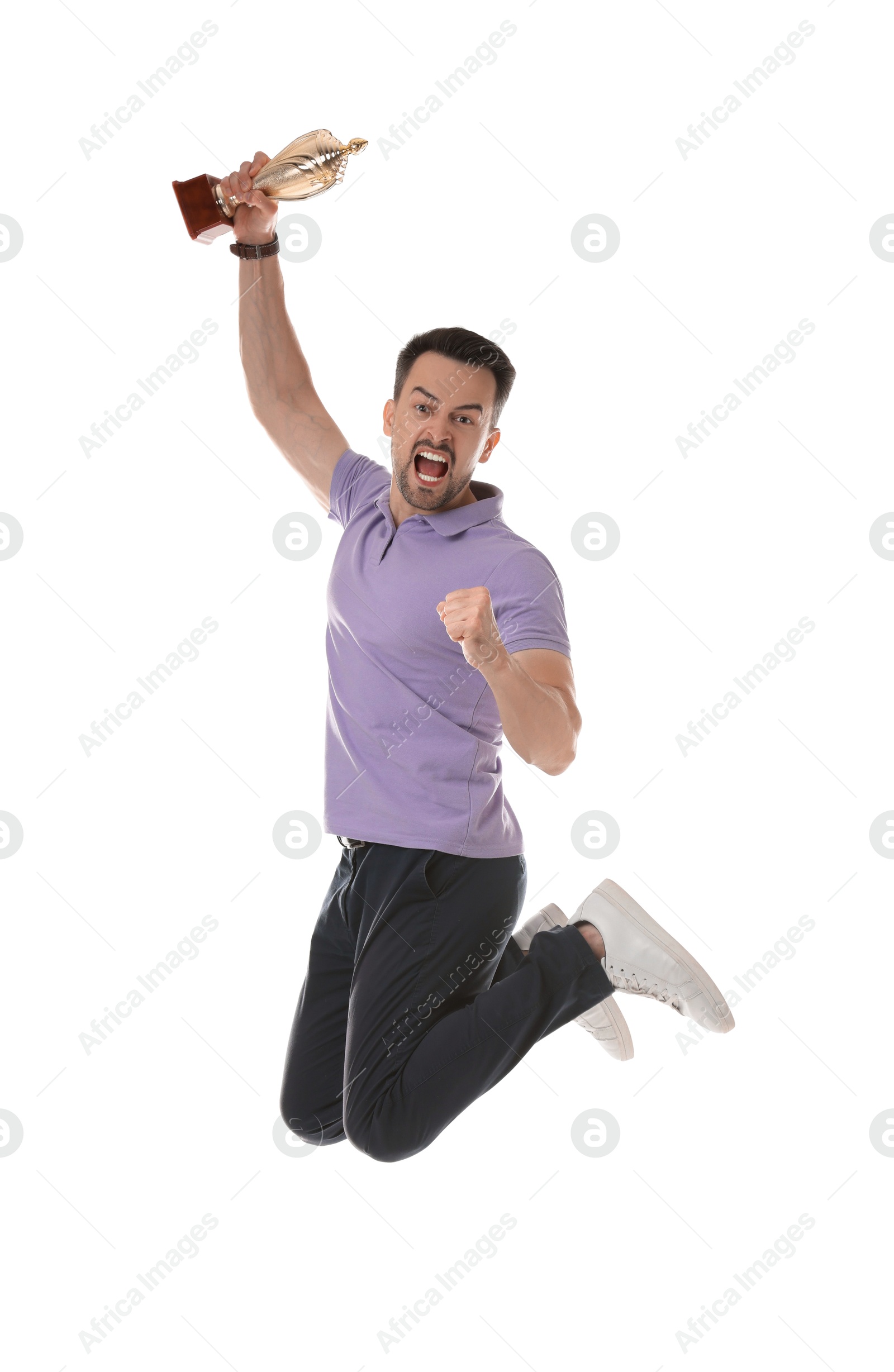 Photo of Happy winner with golden trophy cup jumping on white background