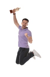 Photo of Happy winner with golden trophy cup jumping on white background