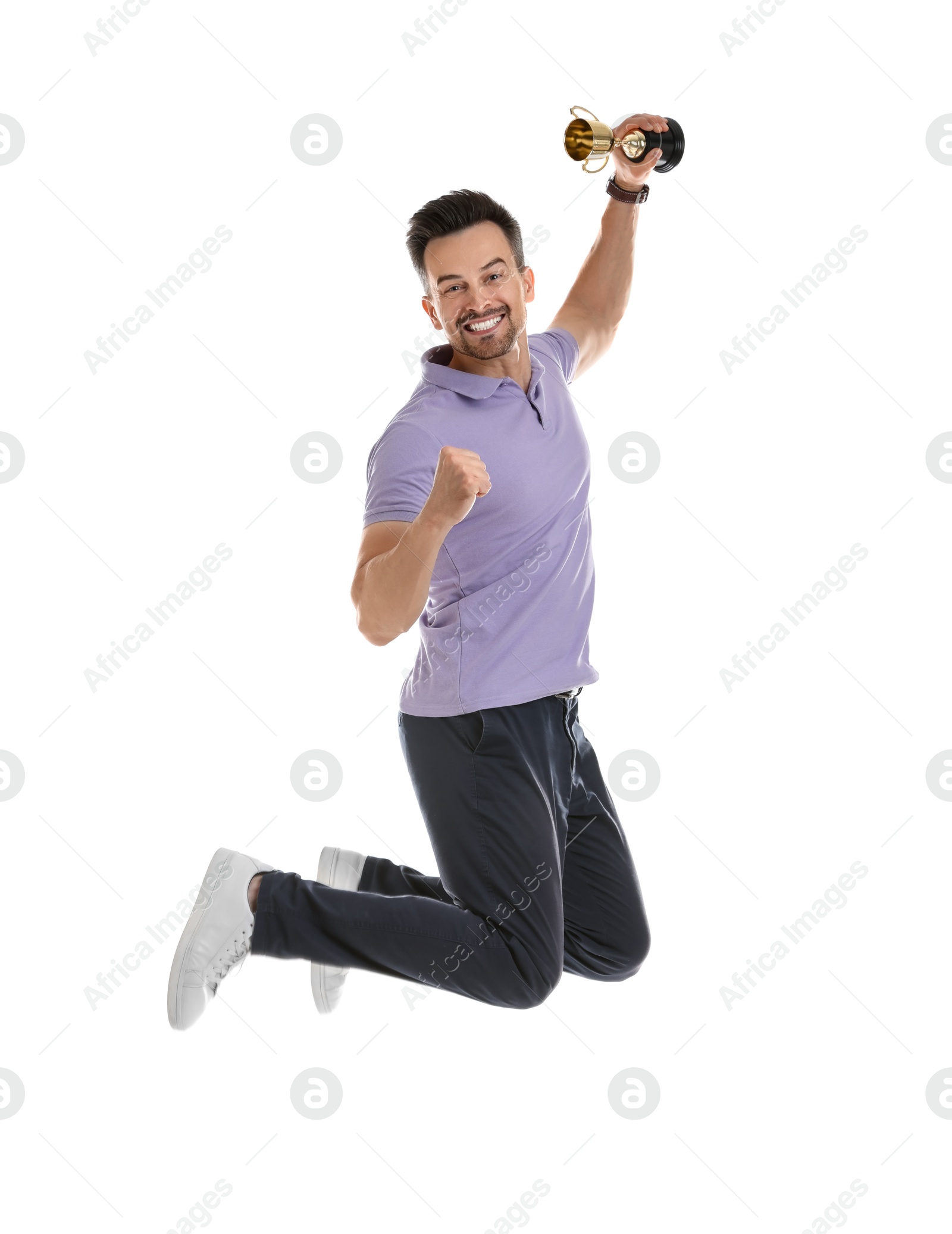 Photo of Happy winner with golden trophy cup jumping on white background