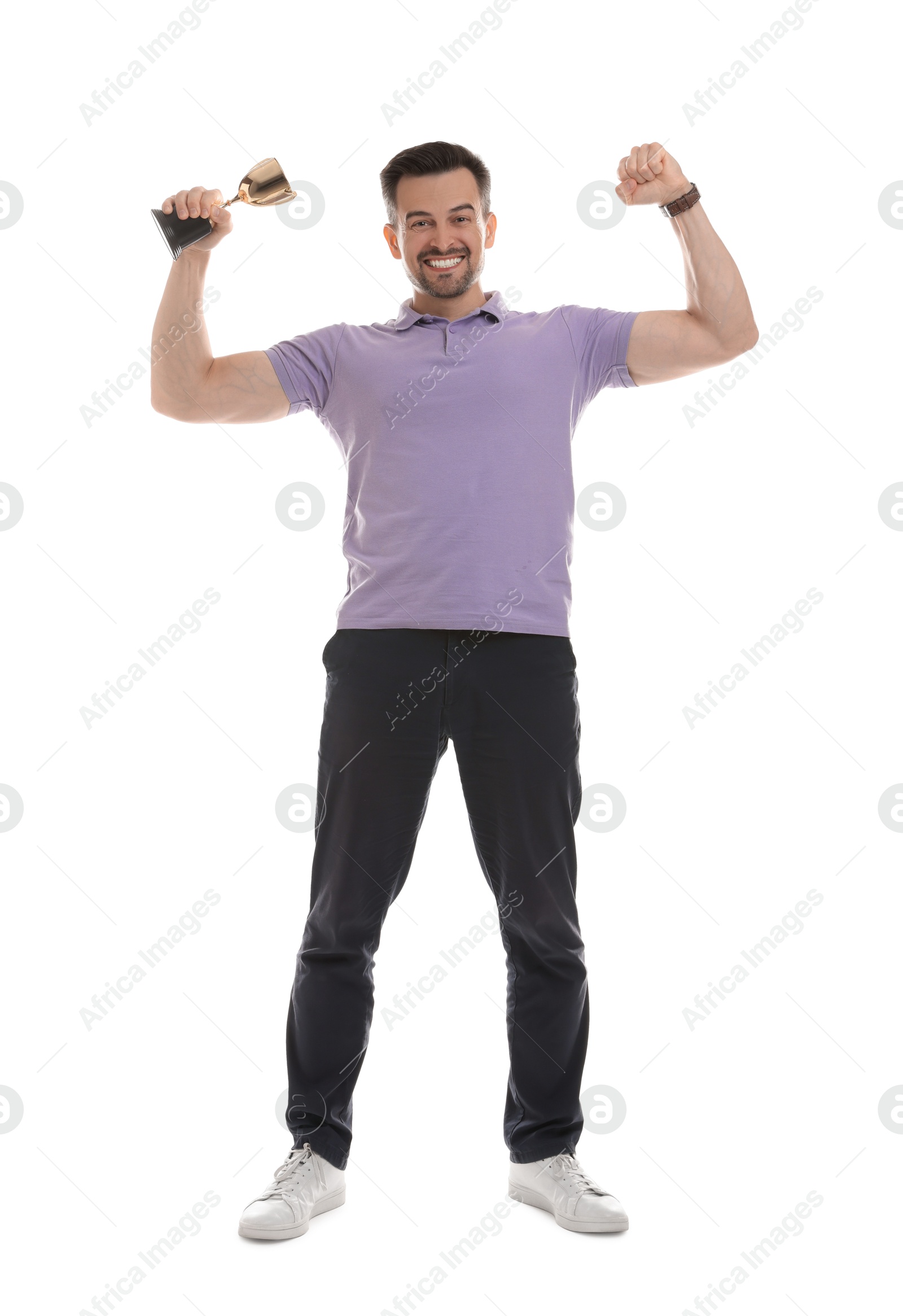 Photo of Happy winner with golden trophy cup showing his biceps on white background