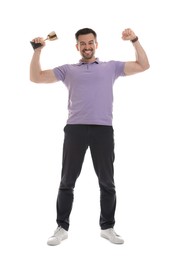 Happy winner with golden trophy cup showing his biceps on white background