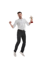 Photo of Happy winner with golden trophy cup jumping on white background