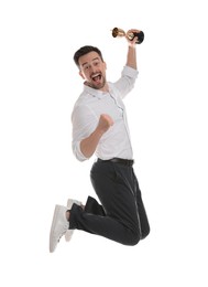 Photo of Happy winner with golden trophy cup jumping on white background