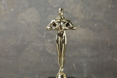 Photo of Golden Oscar award against blurred gray background