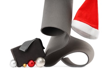 Photo of Yoga mat, block, Santa hat and baubles isolated on white