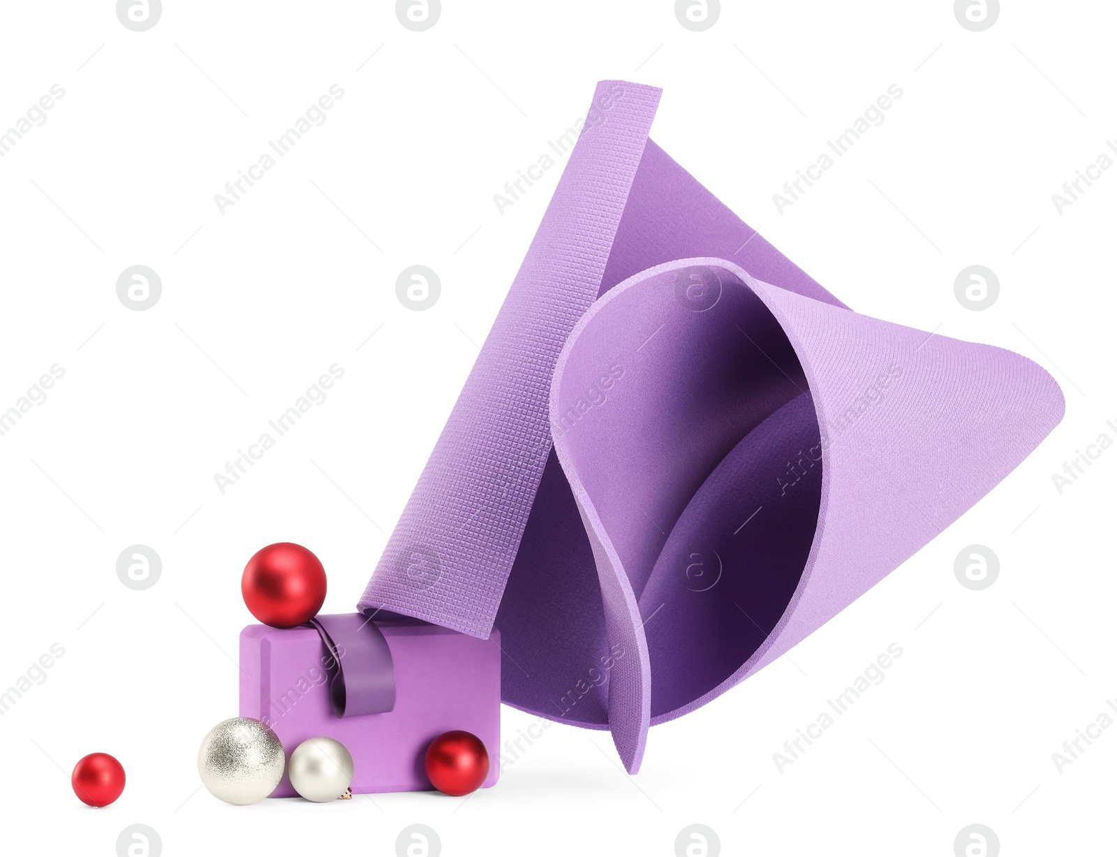 Photo of Yoga mat, block and baubles isolated on white