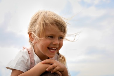 Portrait of happy little girl outdoors. Space for text