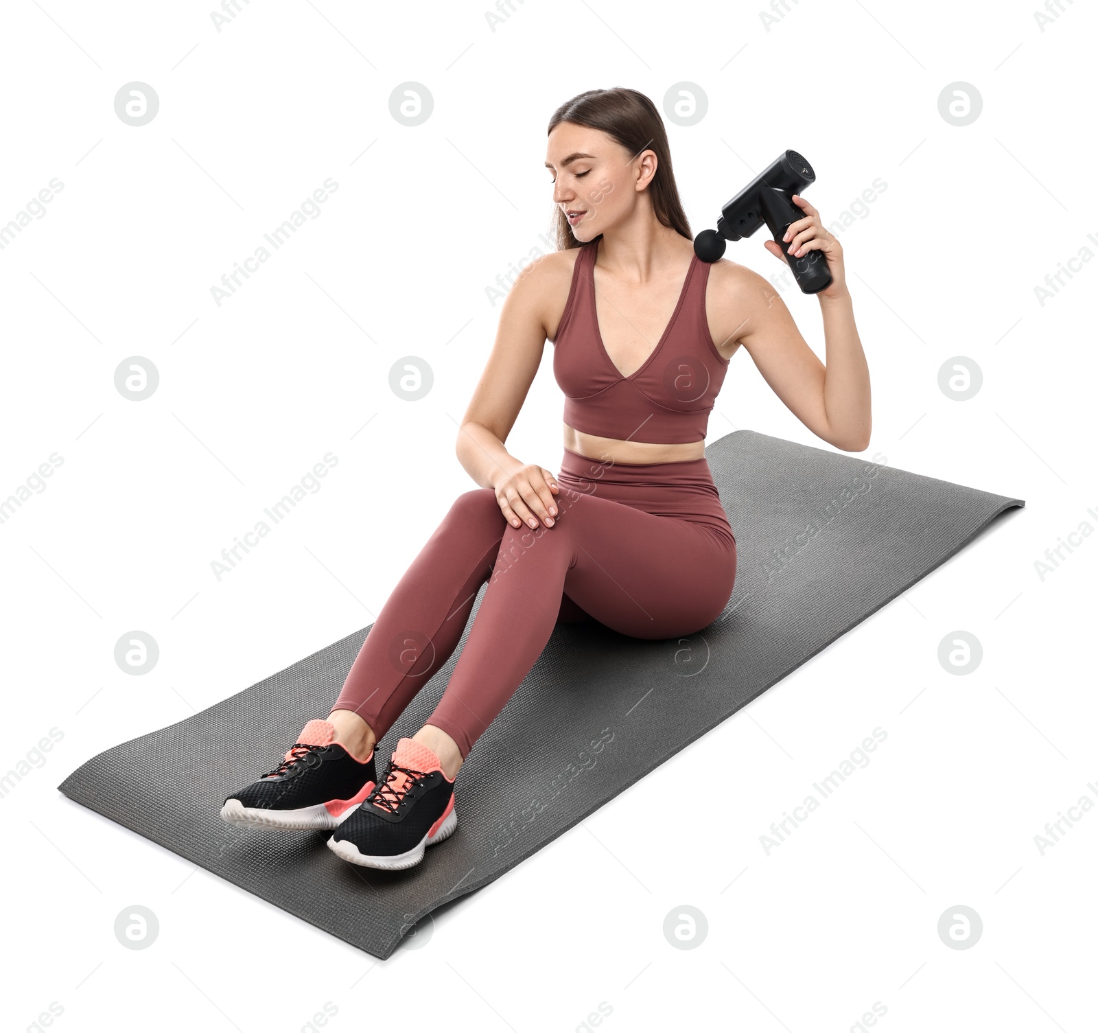 Photo of Woman using percussive massager to relieve trapezius muscle on white background