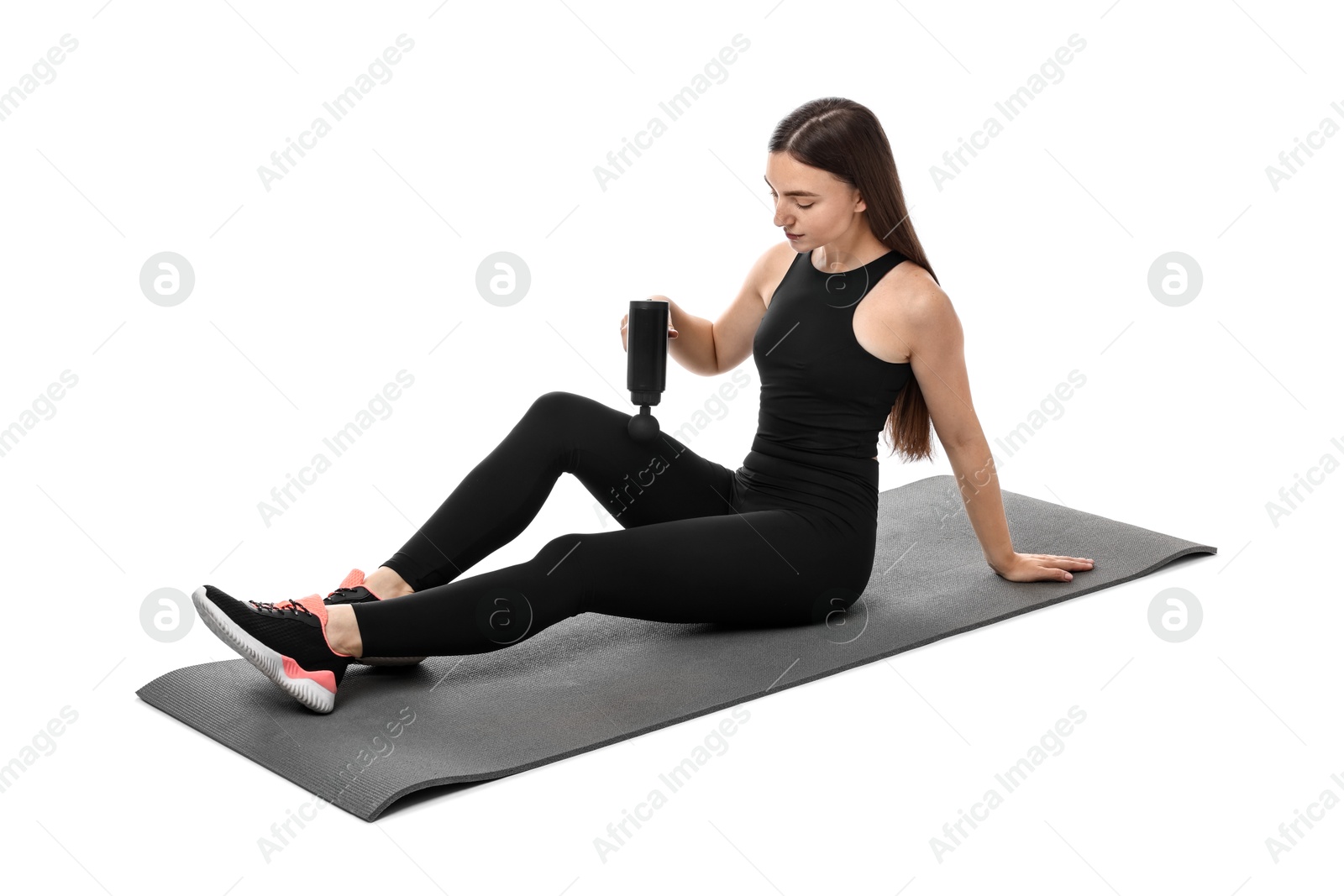 Photo of Woman using percussive massager to relieve thigh muscles on white background