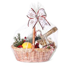 Photo of Wicker gift basket with sparkling wine and Christmas decor isolated on white