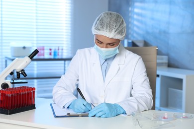 Laboratory testing. Doctor working at table indoors