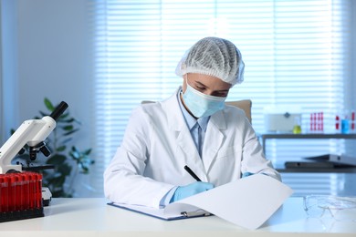 Photo of Laboratory testing. Doctor working at table indoors