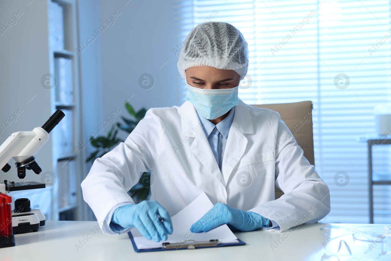 Photo of Laboratory testing. Doctor working at table indoors