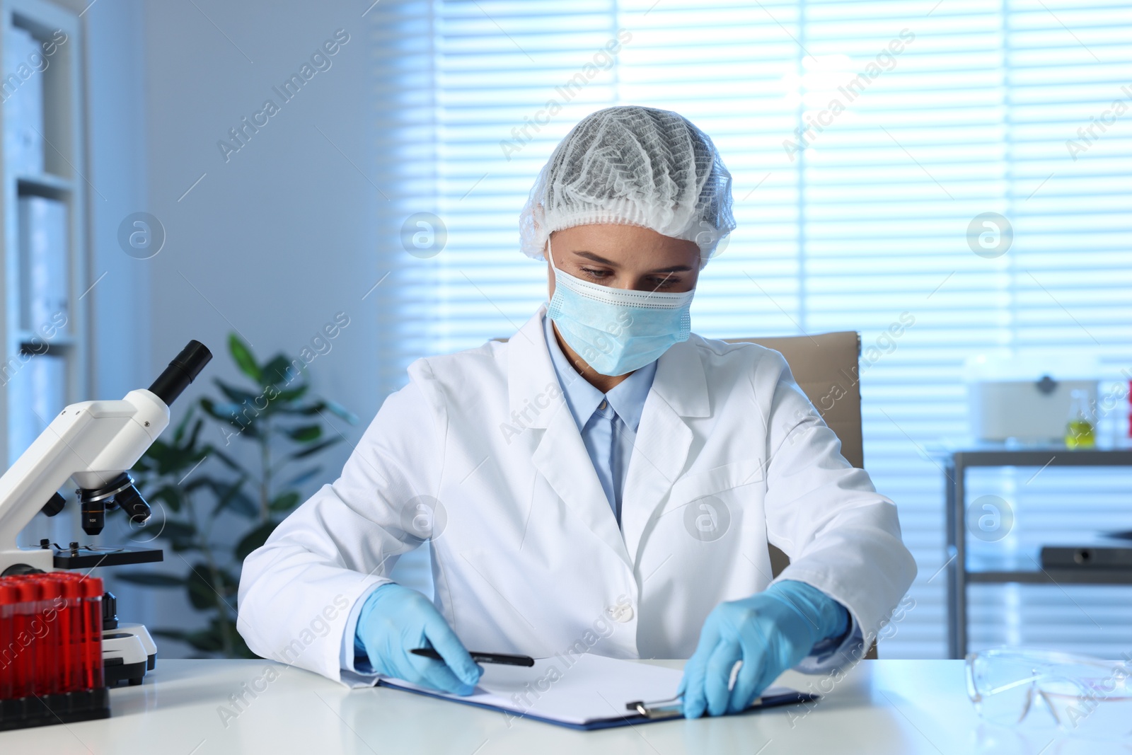 Photo of Laboratory testing. Doctor working at table indoors