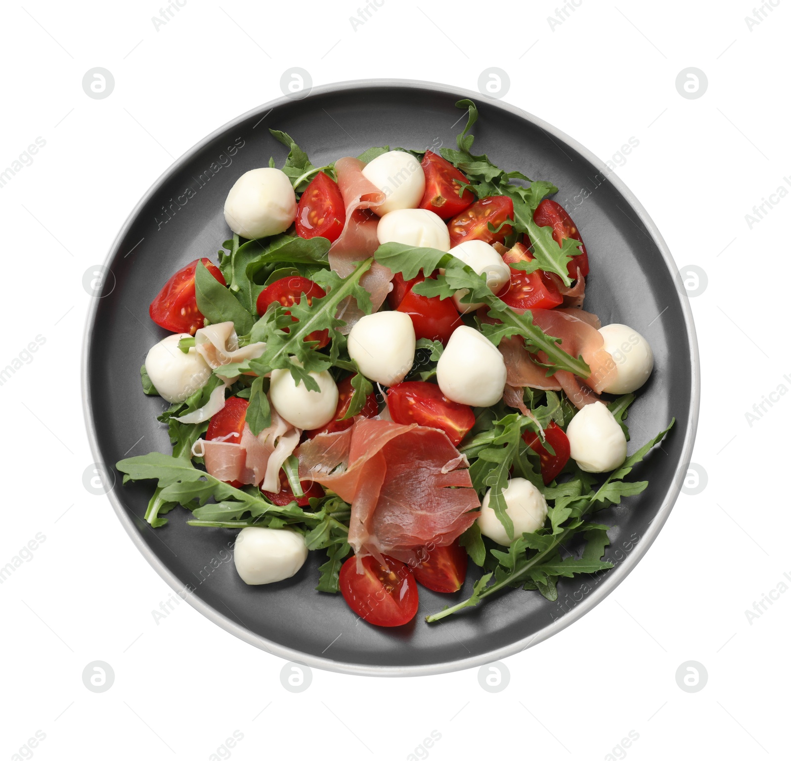 Photo of Tasty salad with arugula, mozzarella cheese, tomatoes and jamon isolated on white, top view